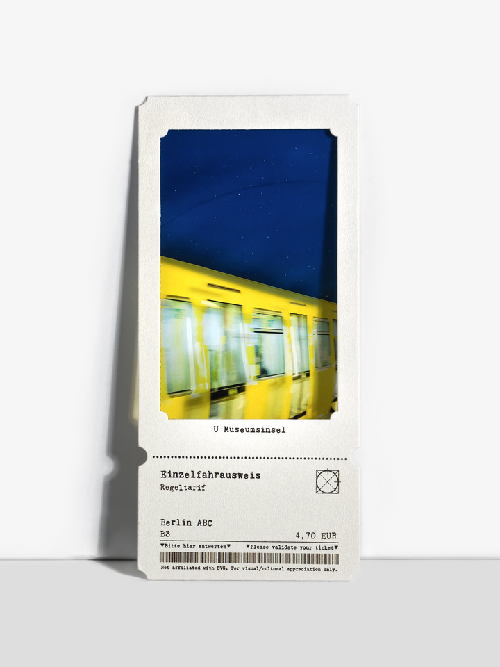 Blurred yellow U-Bahn train gliding under a deep blue celestial dome.