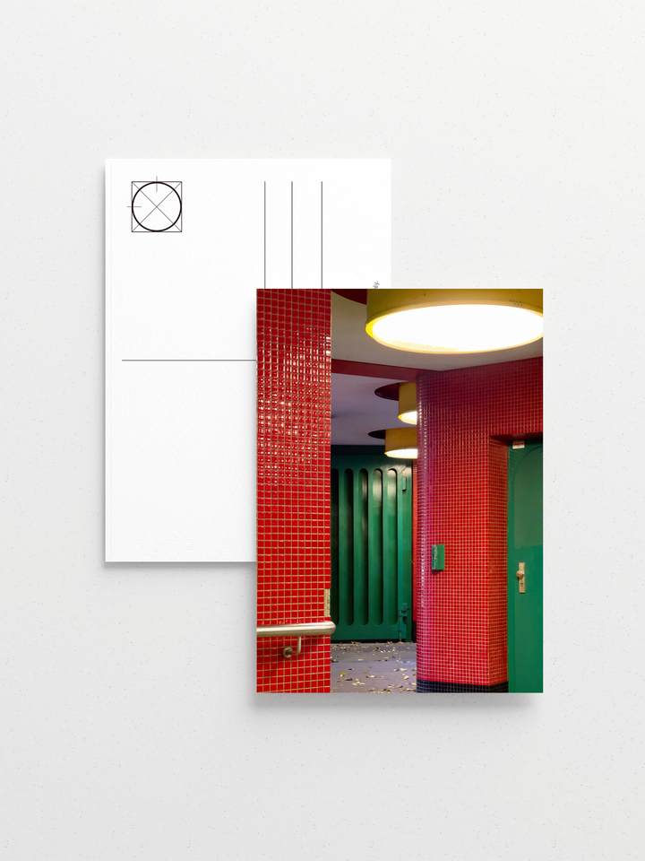 Red and green U-Bahn platform corner with hand-stamped station name.